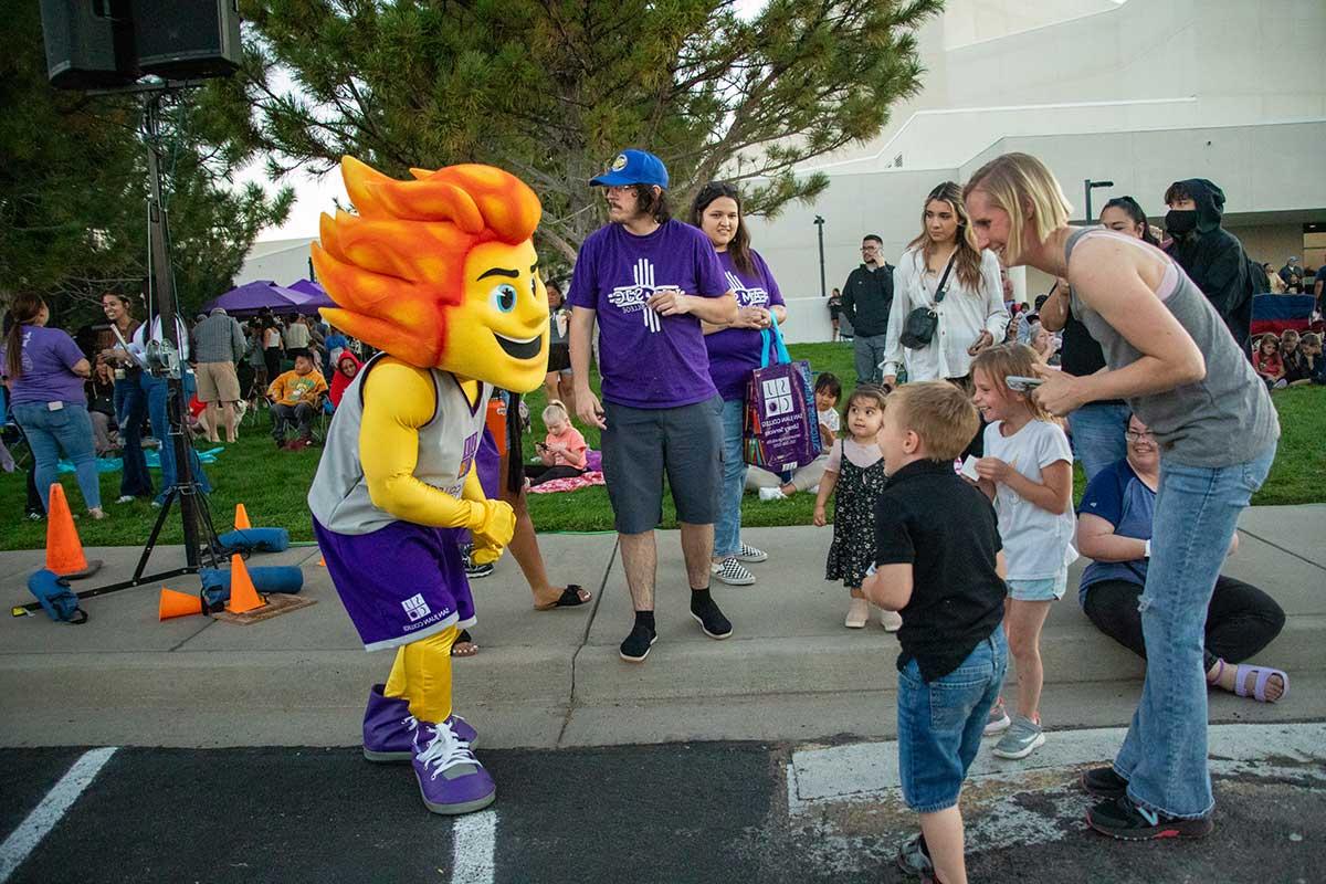 Community members meeting Mascot Blaze at San Juan College Balloon Glow.